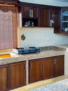 a kitchen with wooden cabinets and a counter top at شقق الياسمين in Jerash