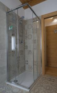 a shower with a glass enclosure in a bathroom at Casa Claudia - Casa Vacanze in Domegge di Cadore