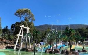 a park with a water park with a fountain at Alpine Hotel, Eat Drink Sleep in Warburton