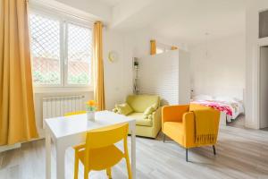 a living room with a table and yellow chairs at AfforiCentro in Milan