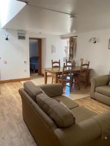 a living room with a couch and a table at Upper Grippath Farm Holiday Cottages in Newport