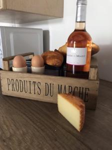 a bottle of wine and some eggs and a piece of cheese at Le Petit Nid in Lesterps