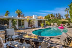 a backyard with a swimming pool and patio furniture at Mirage Cove in Rancho Mirage