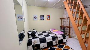 a bedroom with a bunk bed and a staircase at Mahkota Aman Guest House - 5pax in Kuantan