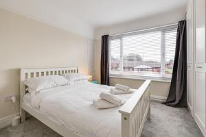 a bedroom with a large white bed and a window at Elegant 3 Bed House near Liverpool City Centre in Liverpool