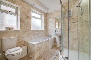 a bathroom with a toilet and a shower and a sink at Elegant 3 Bed House near Liverpool City Centre in Liverpool