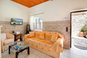 a living room with a couch and a table at Nina Apartment in Gaios