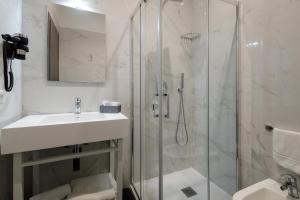 a white bathroom with a sink and a shower at Best Western Hotel dei Mille in Naples +52 photos