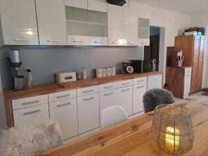 a kitchen with white cabinets and a wooden floor at Gnaden- und Ferienhof Saale Wittgenstein in the middle of gar nix in Bismark