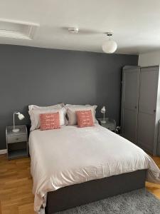 a bedroom with a large bed with two pillows at Modern Apartment in Trendy Dalston in London