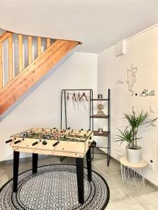 a chess board on a table in a room with a staircase at Jolie maison 2 chambres - CLIM MOBILE - TV - Proche d un lac in Ruelle-sur-Touvre