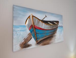 a painting of a boat on the beach at Giasemi Room No 8 Folegandros in Livadi Astypalaias