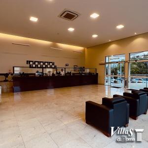 un vestíbulo con un restaurante con barra y sillas en Hotel Villas diRoma com um dia de acesso no diRoma Acqua Park,, en Caldas Novas