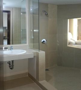 a bathroom with a sink and a shower at U Residence Tower2 Supermal by Lippo Karawaci in Klapadua