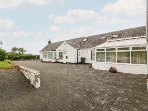 a large white building with a lot of windows at Whiteside Cottage in Darvel