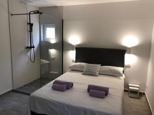 a bedroom with a large bed with two pillows on it at Apartmani Milka i Jozo in Omiš +39 photos
