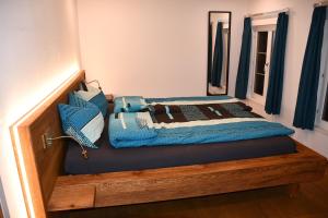 a bed with blue pillows on top of it at Hof-Fankhauser in Wasen