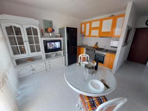 a kitchen with a table and a tv in it at Split apartment in Split