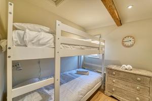 a bedroom with a bunk bed and a clock at Host & Stay - Gleanings in Bredon