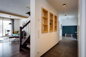 a hallway with a staircase and a living room at Urlaub am Schwarzbach mit Sauna und Whilpool in Butgenbach