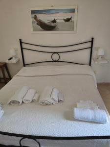 a bedroom with a bed with towels on it at Villa Cala Sinzias in Castiadas