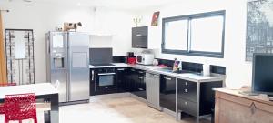 a kitchen with stainless steel appliances and a window at Gite les carriaux in Le Fied