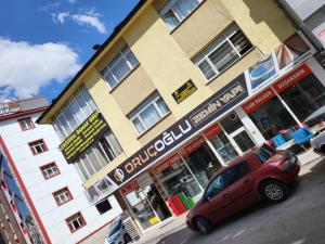 un coche rojo estacionado frente a un edificio en Erzurum DAMAK GRUP, en Erzurum