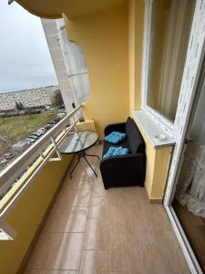 a living room with a couch and a window at Rebeka 2 in Nyíregyháza +3 photos