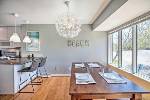 a dining room with a table and a chandelier at Lakefront Family Retreat with Grill Steps to Beach! in Gary