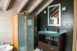 a bathroom with a sink and a shower at Apartamentos Villa Fresnedo in Solares
