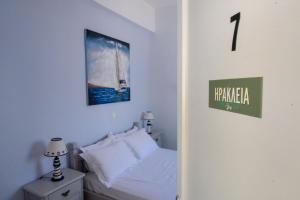 a bedroom with a bed and a sign on the wall at Giasemi Room No 7 Irakleia in Livadi Astypalaias