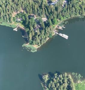 an aerial view of a lake with a boat in it at Villa Linnunlaulu in Löparö