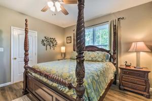 a bedroom with a large bed with a wooden frame at Remodeled Downtown Hot Springs Home with Porch! in Hot Springs