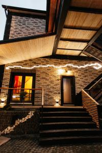 a brick building with stairs and lights on it at loft apartments OLD MILL in Sarny