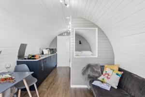a living room with a couch and a table at Bramley, Apple Tree Glamping, Nr Wells in Wells