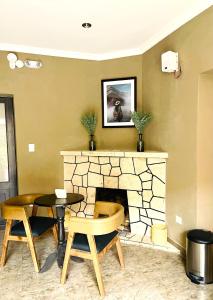 a living room with a fireplace and a table and chairs at CASA MONTES PARDO in Cusco