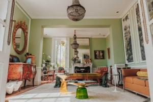 a living room with a couch and a table at Chateau Tanesse de Tourny in Bayon