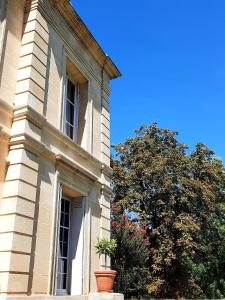 - un bâtiment avec une fenêtre et un arbre à côté dans l'établissement Chateau Tanesse de Tourny, à Bayon