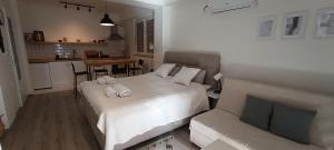 a bedroom with a bed and a kitchen with a table at Petar Apartment in Ohrid