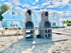 a house on the beach with a grill in the sand at BALTIC FAMILY Premium in Mielno