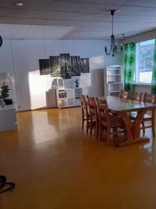 a dining room with a table and chairs at Tilava180m2 asunto in Kokkola +8 photos