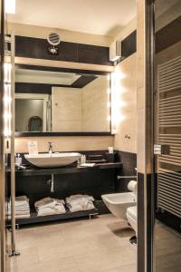 a bathroom with a sink and a mirror at La Corte Di Giulietta in Verona