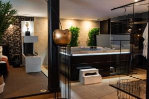 a bathroom with a large tub in a room at La Charmeuse (Suite privée pour amoureux in Belin-Beliet