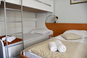 a bedroom with two bunk beds with towels at Hotel Sirena Hvar in Hvar