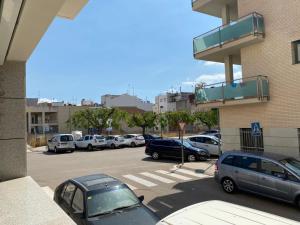a parking lot with a bunch of cars parked at Belmar in Les Cases d'Alcanar