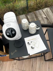 a table with two mugs and two cups on it at Home Sweet Dôme in Bouillon in Noirefontaine