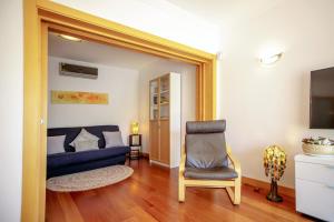 sala de estar con sofá azul y silla en Luxury Apartment with Pool, en Albufeira