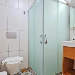 a bathroom with a shower with a toilet and a sink at Akcapinar Korfez Butik Otel in Akyaka +74 photos
