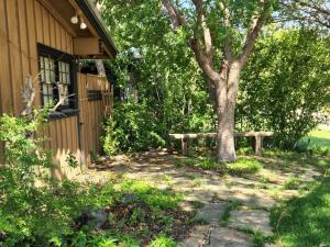 a bench sitting next to a tree next to a house at Home of the Brave 2 in Lawton