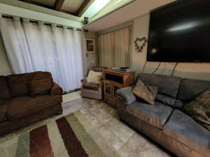 a living room with a couch and a large flat screen tv at Home of the Brave 2 in Lawton